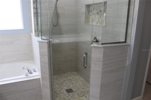 bathroom featuring plus walk in shower