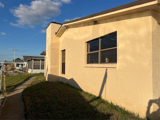 view of side of home featuring a yard