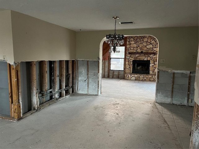 unfurnished living room featuring a stone fireplace