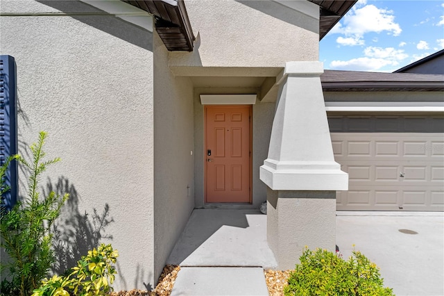 view of exterior entry featuring a garage