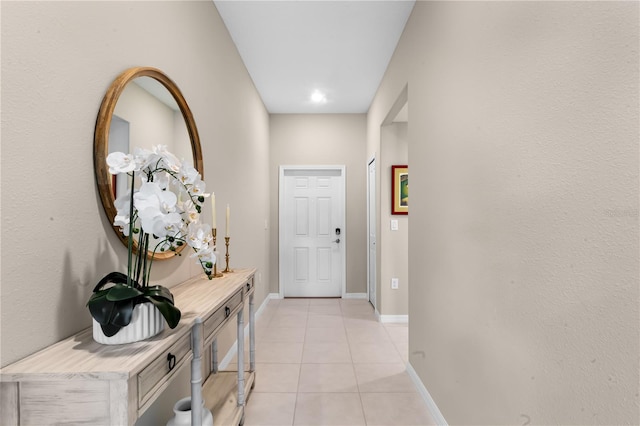 hall featuring light tile patterned flooring