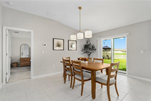 dining area with light tile patterned floors and lofted ceiling