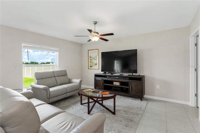 living room with ceiling fan and light tile patterned floors