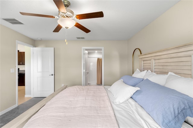 carpeted bedroom featuring ensuite bathroom and ceiling fan