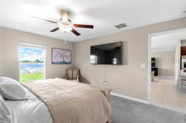 bedroom featuring access to outside, ceiling fan, and light carpet