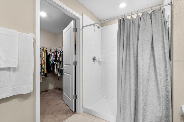 bathroom with tile patterned flooring and curtained shower