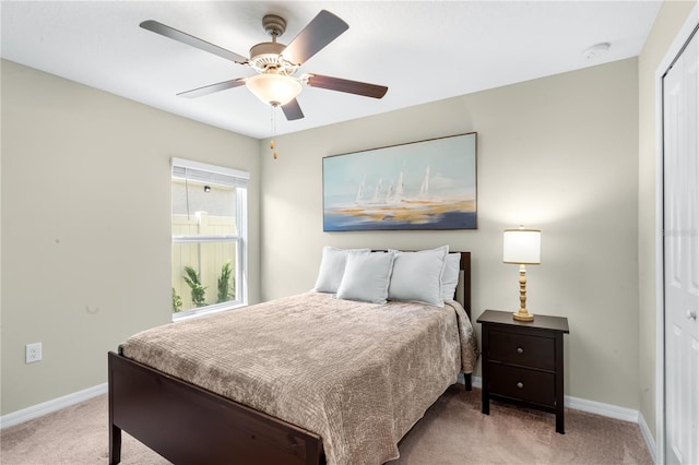 carpeted bedroom with ceiling fan and a closet