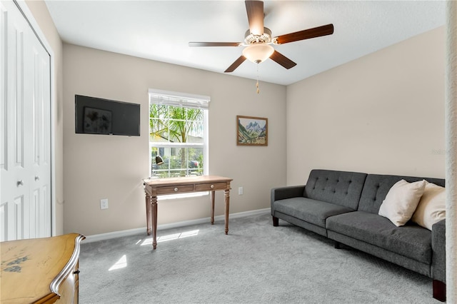 carpeted living room with ceiling fan