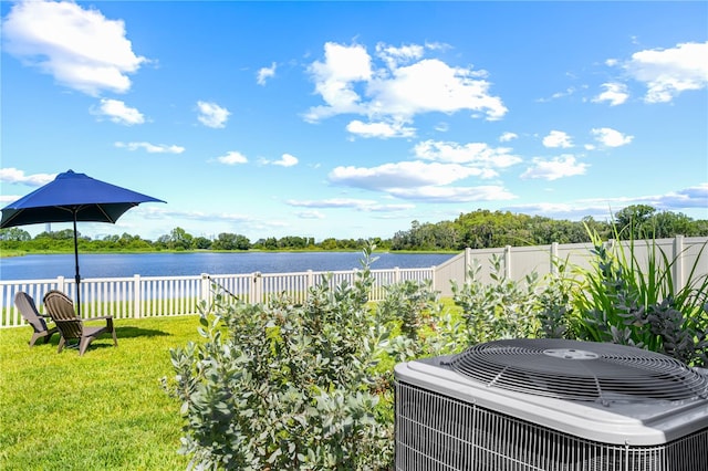 view of yard with a water view and central AC