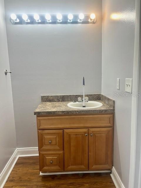 bathroom with hardwood / wood-style floors and vanity