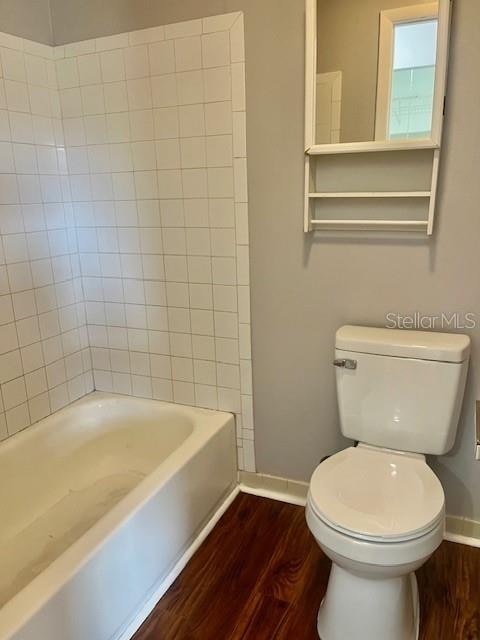 bathroom with toilet and wood-type flooring