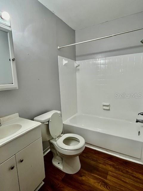 full bathroom featuring wood-type flooring, vanity, toilet, and  shower combination