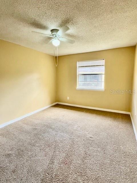 unfurnished room with a textured ceiling, carpet floors, and ceiling fan