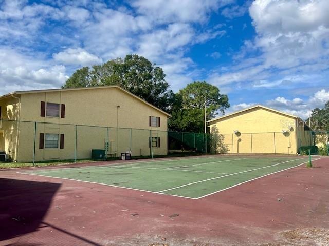 view of tennis court featuring basketball hoop