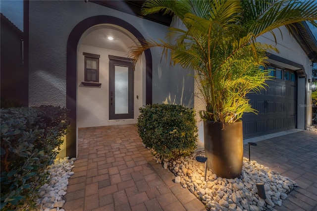 view of exterior entry featuring a garage