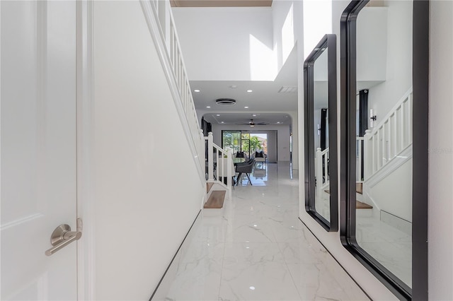 hallway featuring a high ceiling