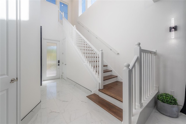 stairway featuring a high ceiling