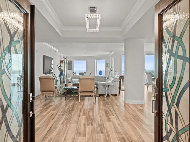 entryway featuring light wood-type flooring and ornamental molding