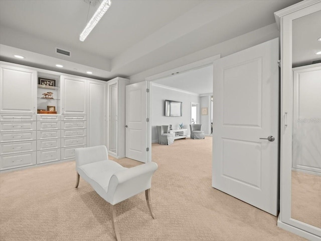 living area with light colored carpet and crown molding