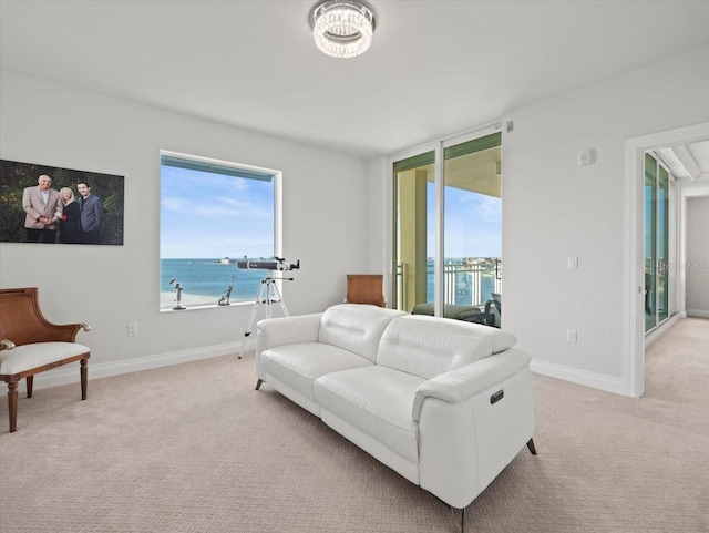 living room featuring a water view and light colored carpet