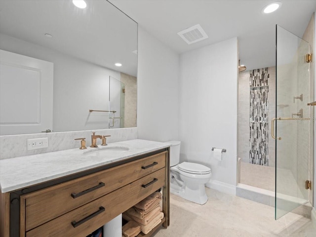 bathroom with vanity, toilet, and walk in shower