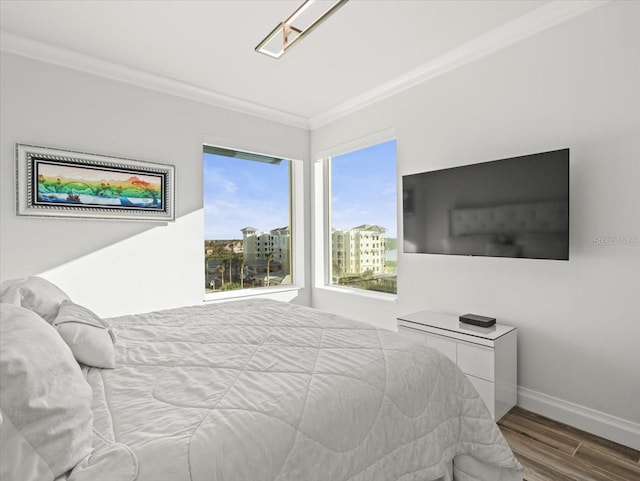 bedroom with hardwood / wood-style floors and ornamental molding