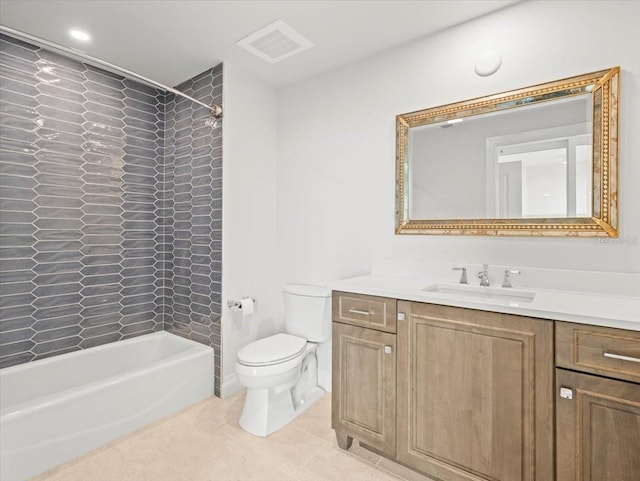 full bathroom featuring tile patterned floors, vanity, tiled shower / bath combo, and toilet