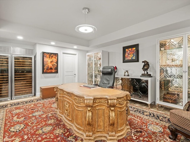 office area with light hardwood / wood-style floors and wine cooler