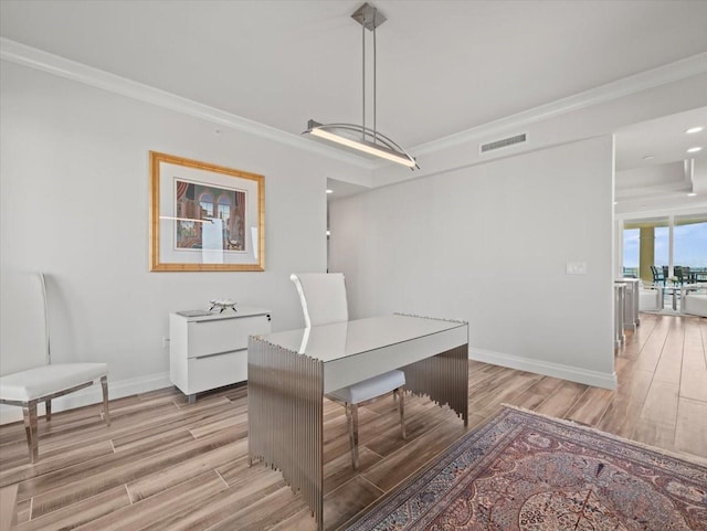 office featuring crown molding and light hardwood / wood-style floors