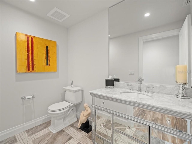 bathroom with vanity and toilet