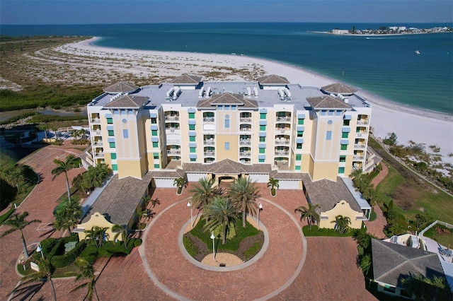 bird's eye view with a water view and a beach view