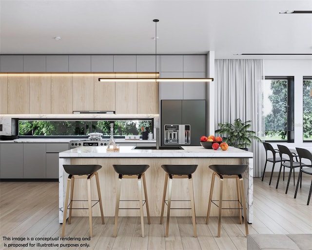 kitchen with a kitchen bar, paneled refrigerator, a healthy amount of sunlight, and a center island