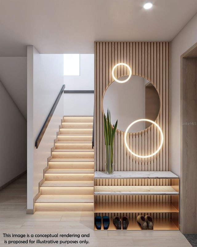 stairway with hardwood / wood-style floors