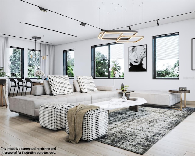 living room with light hardwood / wood-style floors, a chandelier, and plenty of natural light