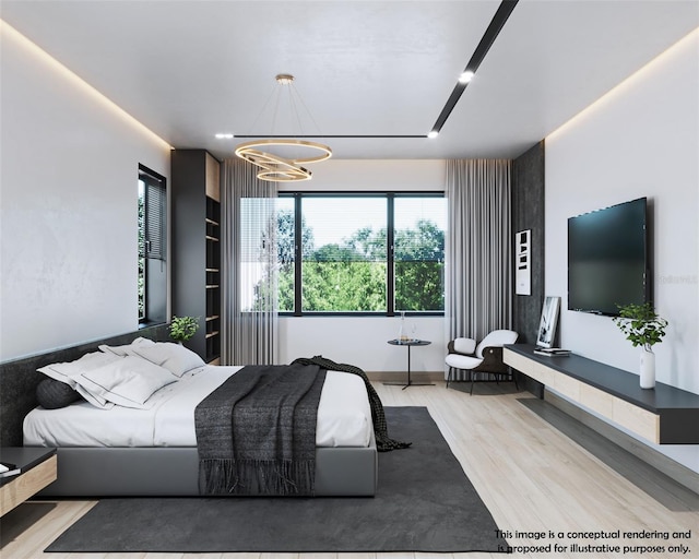 bedroom with a chandelier and light hardwood / wood-style floors