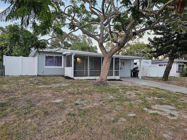 view of front of house with a sunroom and a carport