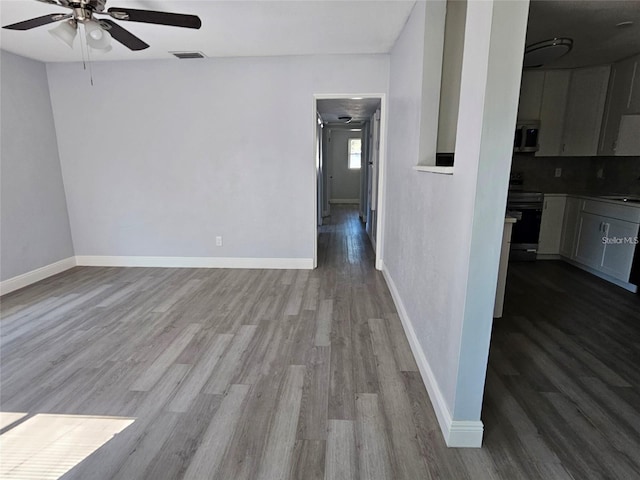 interior space with ceiling fan, light hardwood / wood-style flooring, and sink