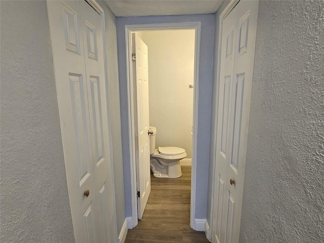 hallway with dark hardwood / wood-style floors