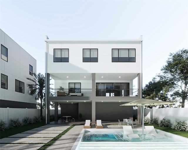 back of house with a fenced in pool and a patio