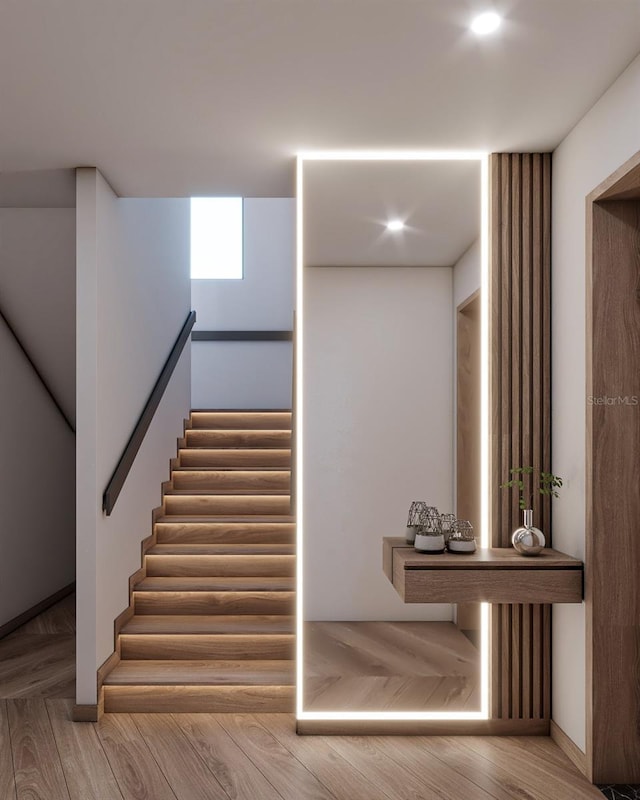 stairs featuring wood-type flooring