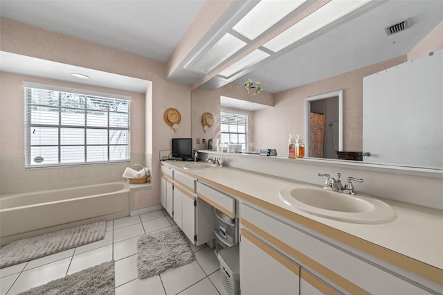 full bathroom featuring double vanity, tile patterned flooring, visible vents, and a sink