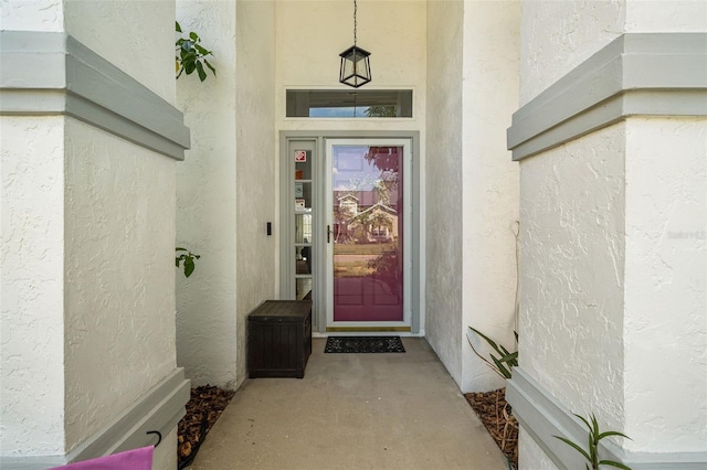 entrance to property featuring stucco siding