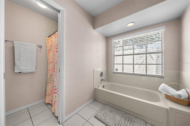 bathroom featuring a garden tub, tile patterned flooring, and baseboards