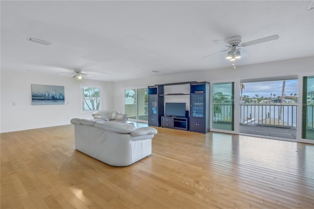 unfurnished living room with light hardwood / wood-style flooring and ceiling fan