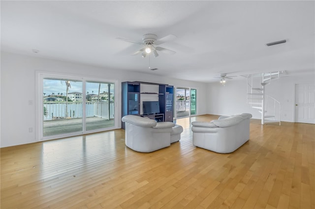 living room with light wood-type flooring and ceiling fan