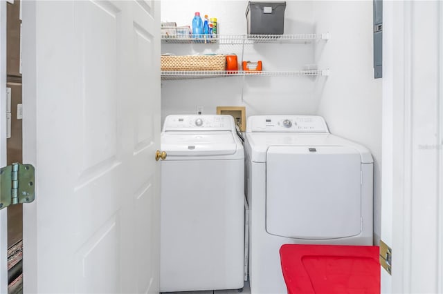 clothes washing area with washing machine and clothes dryer