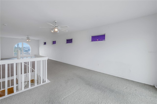 carpeted spare room with ceiling fan