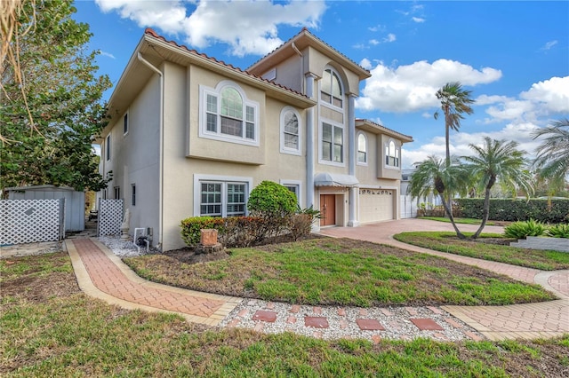 view of front of house with a garage and a front lawn