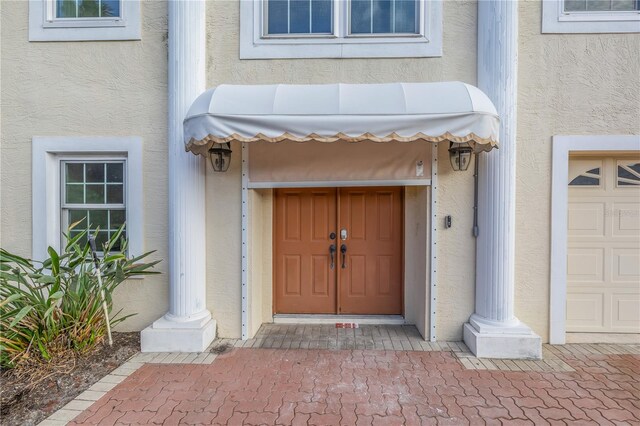 view of exterior entry featuring a garage