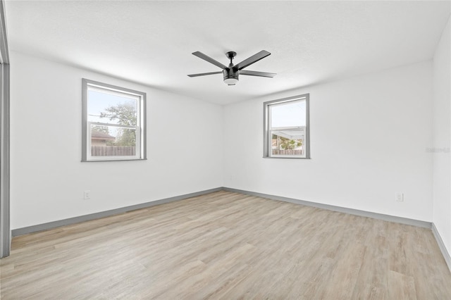 unfurnished room with a textured ceiling, light hardwood / wood-style floors, plenty of natural light, and ceiling fan